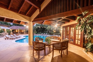 Gather in the guest house's patio with views of the pool.