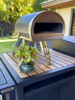 Gas-fired pizza oven, adding a unique culinary touch to outdoor dining.