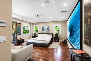 Guest suite with king bed, projection screen, and contemporary décor.