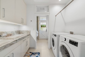 Conveniently located laundry nook offering full washer and dryer for guest use.
