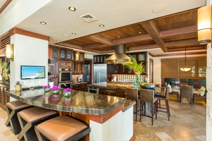 Designed for entertaining, the chef's kitchen features premium appliances, rich wood finishes, and generous space for cooking and gathering.