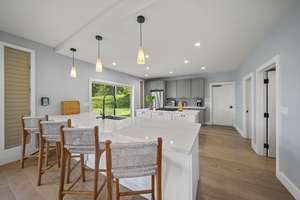 Bright and inviting kitchen breakfast bar with seating for 4, ideal for casual meals.