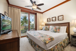 The second guest bedroom boasts expansive views, a cozy bed, and a TV for entertainment after a day of Hawaiian adventures.
