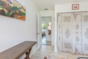 Hallway view with linen storage and access to full upstairs bathroom.