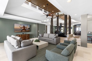 Unwind in your spacious living room featuring plush seating, soaring ceilings, and modern design that creates the perfect atmosphere for relaxation.