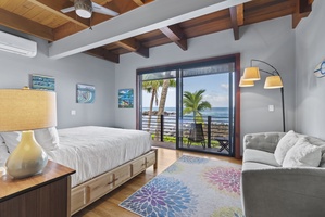 Bright bedroom with a king-size bed and beautiful ocean vistas.