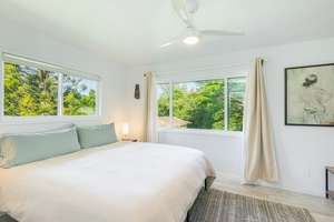 Wake up to greenery in this serene upstairs retreat with wraparound windows.