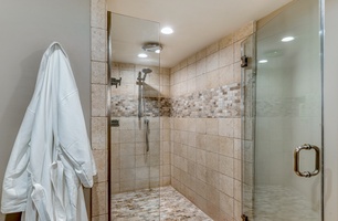 Mahana 1119 features a luxurious walk in shower with modern tile and space to unwind in peace.