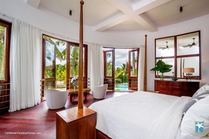 Wake up to the stunning views in the guest bedroom with a private balcony overlooking the pool.