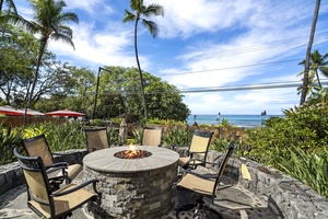 Firepit lounge with seating for six, perfect for evening gatherings by the ocean.