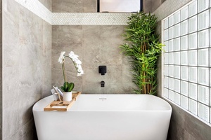 Primary suite with a chic soaking bath tub