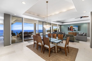 Imagine dining with endless ocean views through floor-to-ceiling windows in your stunning open-plan living space with elegant modern furnishings.
