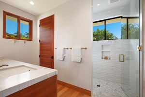 Bright and airy bathroom with a luxurious soaking tub and walk-in shower.