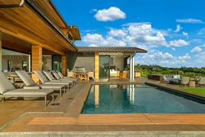 Stunning modern property featuring a private pool and hot tub, outdoor dining area, and expansive terrace with panoramic views of lush tropical landscape.