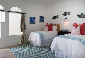 Guest bedroom with two twin beds and coastal decor.
