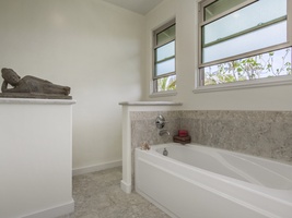 Primary bath with deep tub for relaxing.