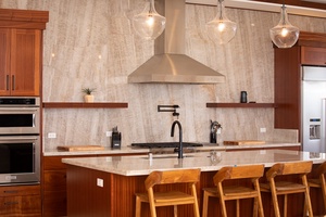 Perfect for entertaining, the heart of the home blends elegance and functionality.