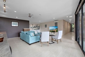 Modern living area with plush seating, a sleek TV setup, and elegant minimalist design.