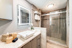 Bright and modern, the second bathroom features a luxurious multi-function shower and elegant finishes for added comfort.