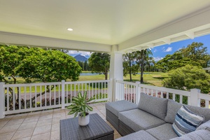 Unwind on the covered patio with plush seating and peaceful green views.