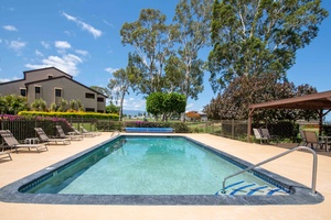 Another angle of Pool Cabana B showing expansive space for relaxation under sunny Hawaiian skies and swaying palms.