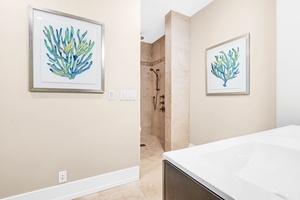Guest suite en-suite featuring a walk-in shower and calming tones.