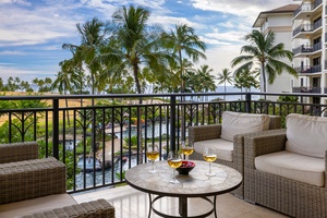 Unwind at sunset on the lanai, surrounded by palm trees and breathtaking ocean views.