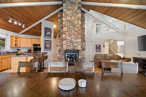 Gather around your stunning stone fireplace in this open-concept space where cooking, dining, and relaxing flow together beautifully.
