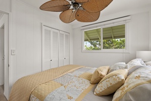 This tropical bedroom has soft linens and gentle breezes from the palm-leaf fan overhead.