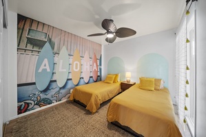Bright and cheerful twin bedroom with island-inspired decor, perfect for a restful stay.