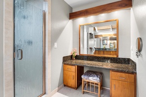 Granite vanity and walk-in shower highlight this well-appointed primary bath.