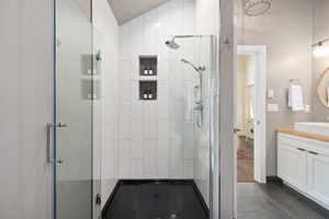 Walk-in shower with clean tile and a rain head for a spa-like feel.