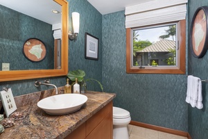 A convenient guest powder room is centrally located.