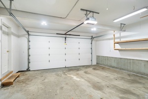 Spacious garage with automatic door opener provides secure parking and convenient storage for your vehicle and belongings.