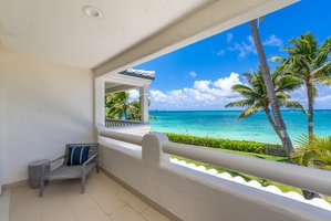 Sip morning coffee or unwind on the balcony just off the queen suite, with postcard views of turquoise waters and swaying palms.
