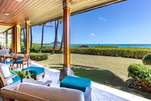 Shaded deck lounge with panoramic ocean views.