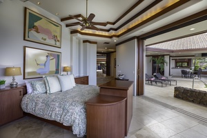 Wake up in this elegant bedroom where rich wood details and artwork create a serene retreat that opens to your private outdoor terrace.