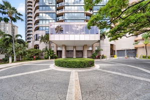 Arrive at Waikiki Landmark with secure entry and tropical landscaping throughout.