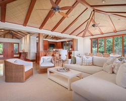 Wide view of the great room & foyer featuring soaring vaulted ceilings