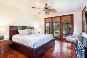 Bright guest bedroom 2 with hardwood floors, king bed, and garden access