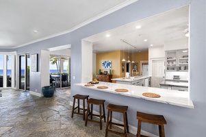 Gourmet kitchen with soaring ceilings, abundant storage, and expansive island seating.