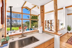 Natural wood and Pacific light frame your every moment—start the day with coffee and bay views right from the sink.
