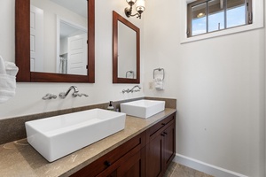 Spacious upstairs guest bathroom with dual vanities.