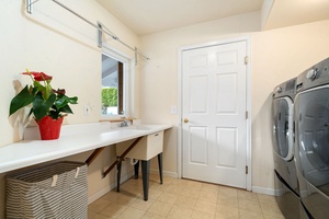 Your dedicated laundry room features a spacious sink for hand-washing delicates and modern appliances to keep your clothes fresh during your stay.