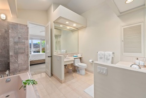 Your spacious bathroom features elegant marble accents, a soaking tub, and premium fixtures for ultimate relaxation during your stay.
