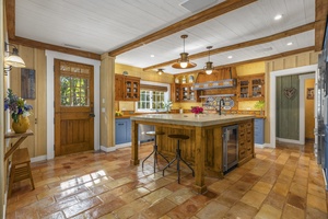 The spacious kitchen has stainless steel appliances for a breezy meal prep.