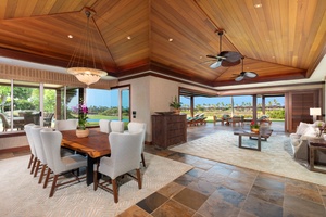 Dining area seats eight with views of lush tropical landscaping and open sky.
