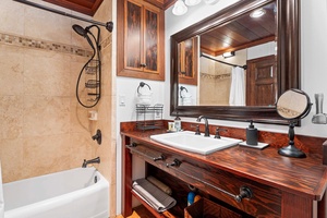 Rustic charm meets modern comfort in this well-equipped primary bathroom.
