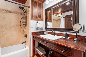 Primary bathroom features a vanity and a tub/shower.