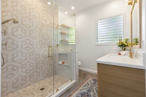 Guest bath with designer tile and glass wall shower